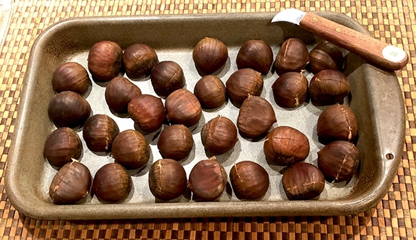 Savor the Season with Chestnutlz - Raw Chestnuts with Knife Photo